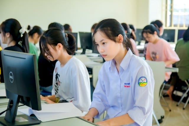 Students at workstations in an English academy classroom